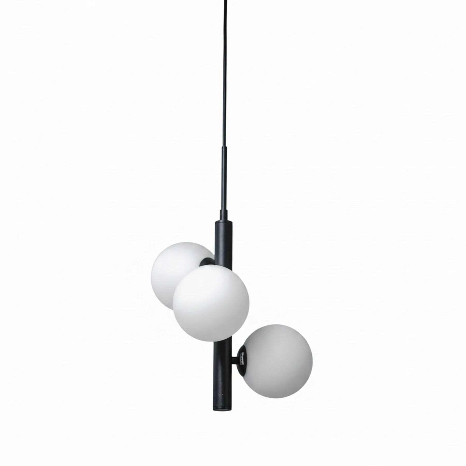 Modern pendant light with three spherical glass shades on a white background