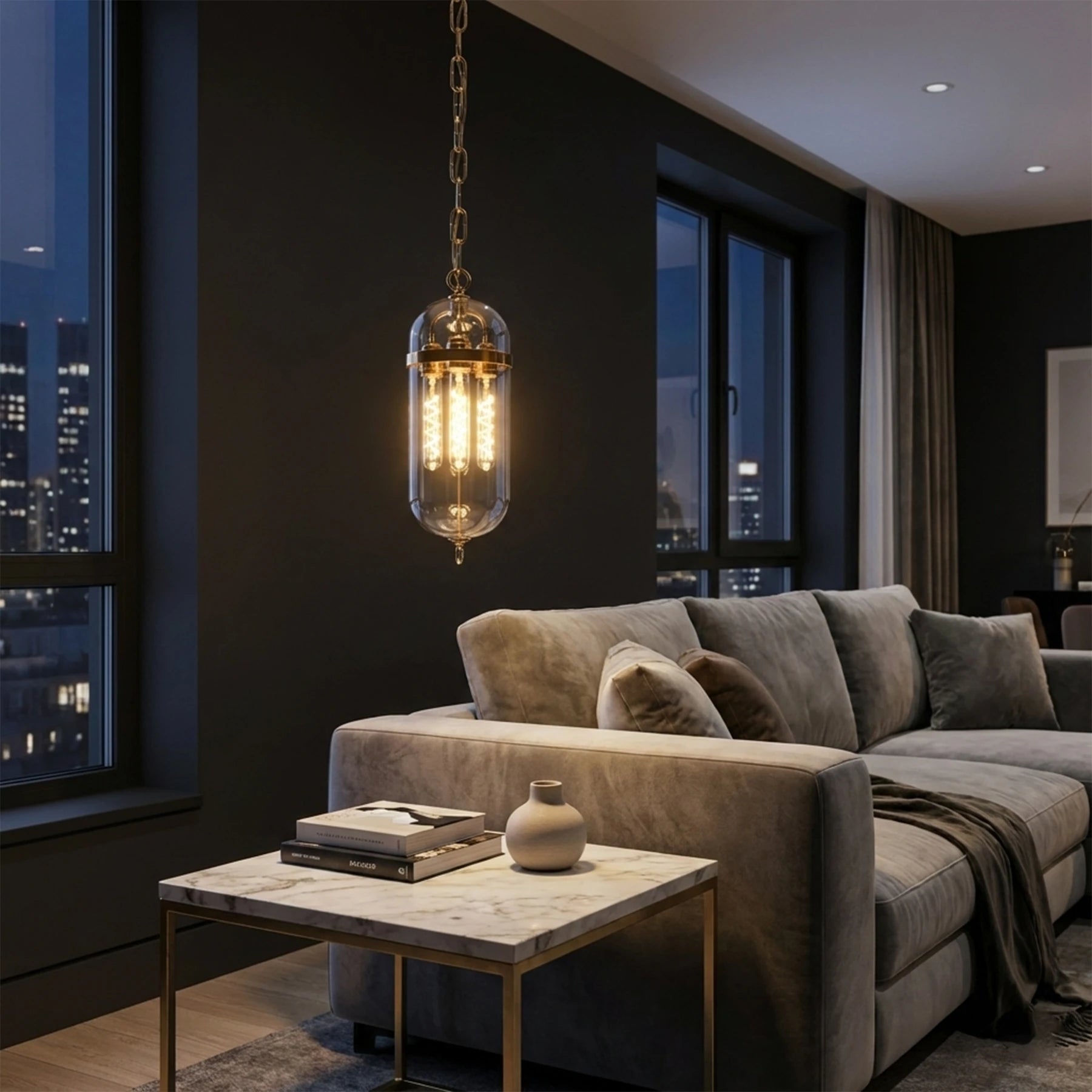 Modern living room with a gray sofa, coffee table, and pendant light.