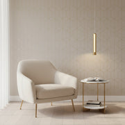 Beige armchair and side table against a geometric-patterned wall.