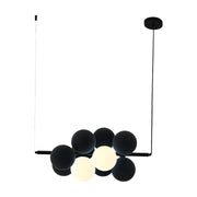 Name Abeeha Celestial Orb Pendant Light in midnight black and white, featuring a modern 10-bulb design with spherical globes on a black metal frame, illuminating a stylish dining room.