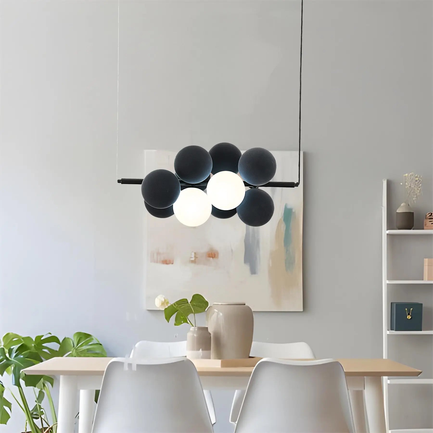 Name Abeeha Celestial Orb Pendant Light in midnight black and white, featuring a modern 10-bulb design with spherical globes on a black metal frame, illuminating a stylish dining 